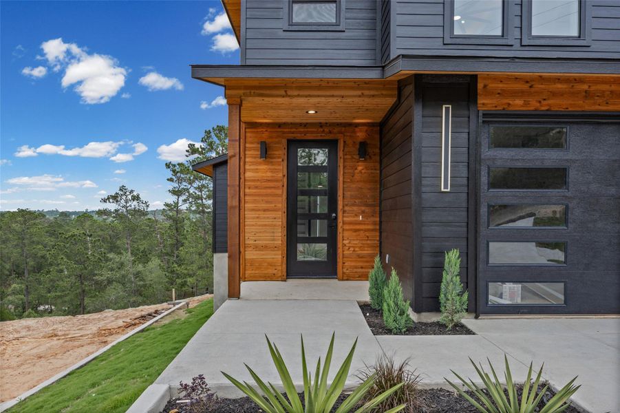 Modern exterior featuring rich wood-finish siding and dark horizontal paneling Modern exterior featuring rich wood-finish siding and dark horizontal paneling