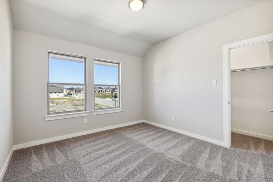 Bedroom in the Morrison home plan by Trophy Signature Homes – REPRESENTATIVE PHOTO