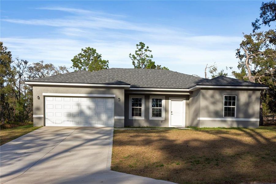 Front exterior of a new home in , Citrus Springs, FL, highlighting curb appeal (Image 14).