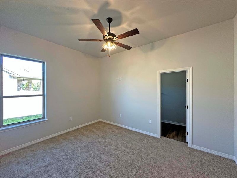 Spare room featuring light colored carpet and ceiling fan Spare room featuring light colored carpet and ceiling fan