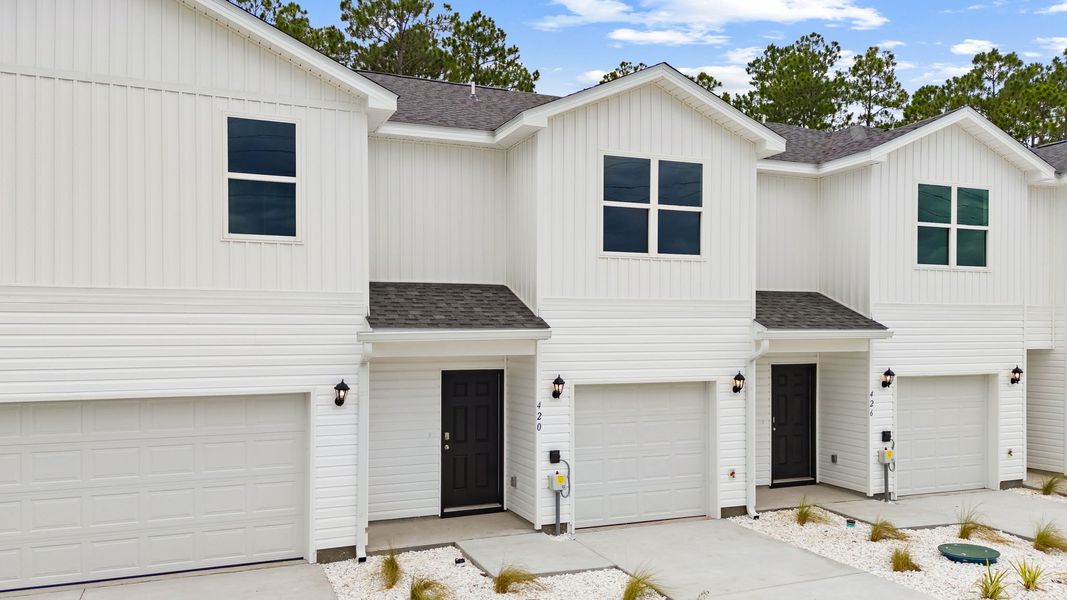 Front exterior of a new home in Chateau Nemours, Port Saint Joe, FL, highlighting curb appeal (Image 2). Front exterior of a new home in Chateau Nemours, Port Saint Joe, FL, highlighting curb appeal (Image 2).