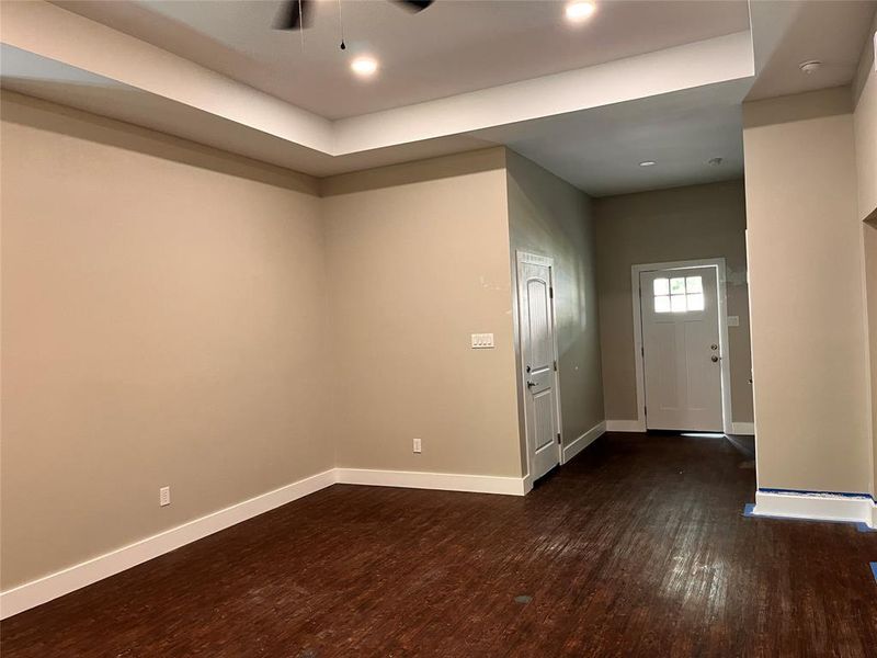 Entrance foyer with ceiling fan and dark hardwood / wood-style flooring