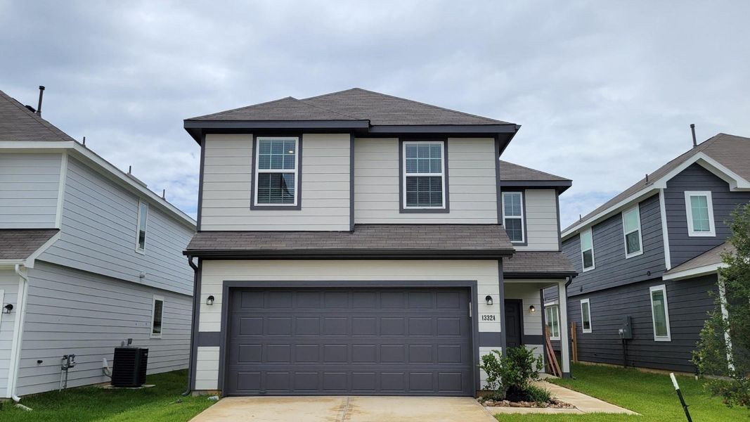 Front exterior of a new home in River's Edge, Conroe, TX, highlighting curb appeal (Image 2). Front exterior of a new home in River's Edge, Conroe, TX, highlighting curb appeal (Image 2).