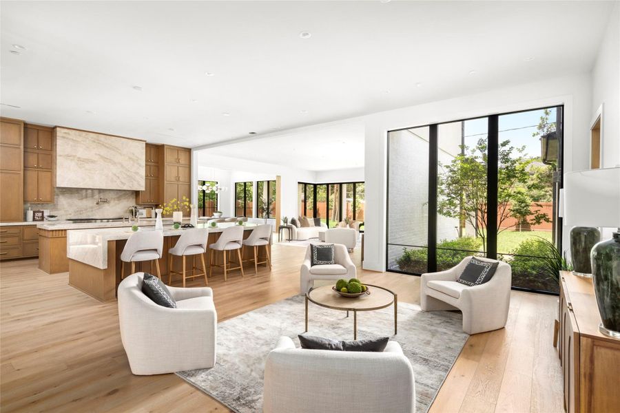 The dowstairs living space features a chef's kitchen, dining area, and large family room with accordion doors. This provides for seamless entertaining and living.