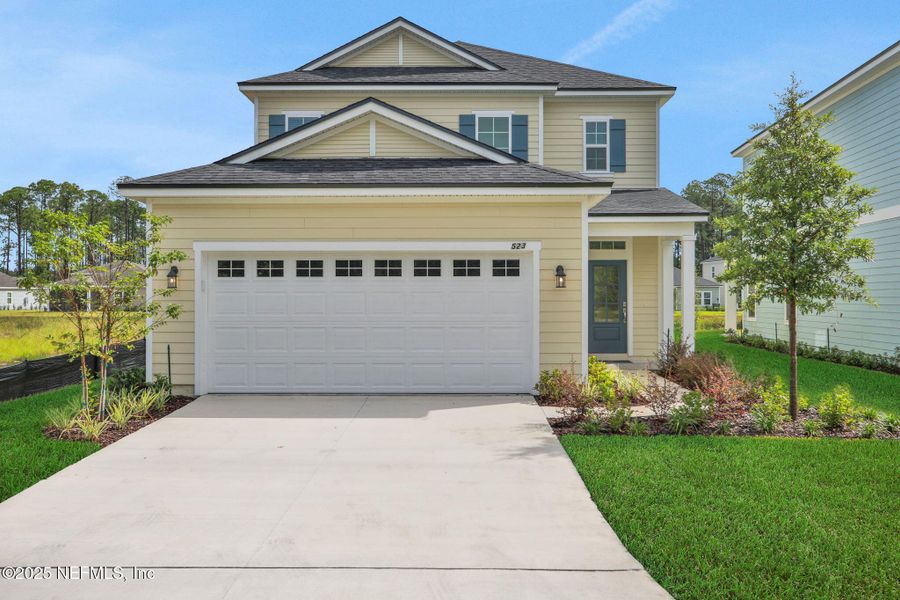 Front exterior of a new home in TrailMark, St. Augustine, FL, highlighting curb appeal (Image 1).