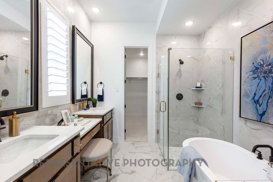 Bathroom with a marble finish shower, light marble finish flooring, a freestanding bath, vanity, and recessed lighting