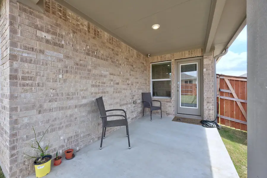 Doorway to property with a patio and brick siding