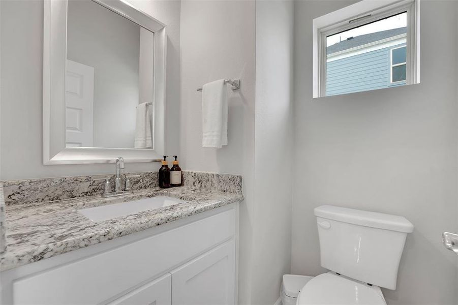 Half bath featuring vanity and toilet