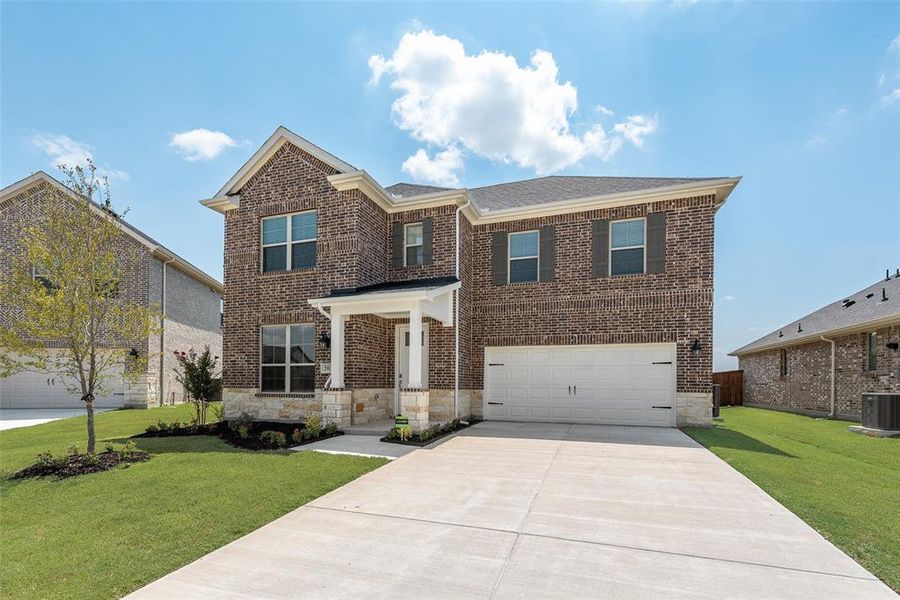 Front exterior of a new home in Walden Pond, Forney, TX, highlighting curb appeal (Image 2). Front exterior of a new home in Walden Pond, Forney, TX, highlighting curb appeal (Image 2).