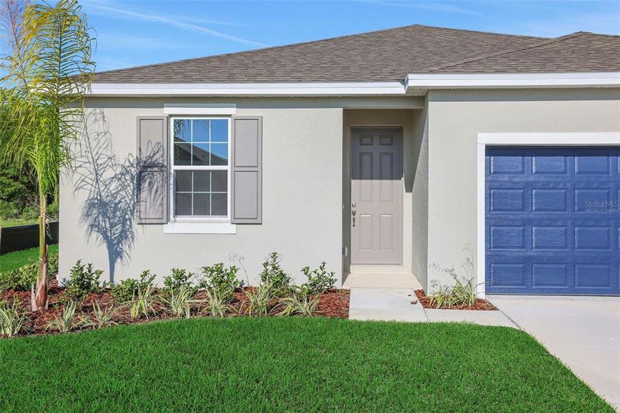 Front exterior of a new home in Seaport Village, Tavares, FL, highlighting curb appeal (Image 16).
