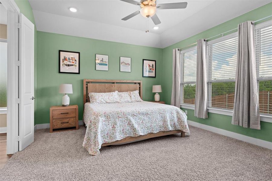 The primary bedroom enjoys views of the backyard through large windows!