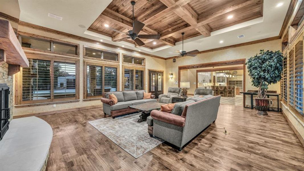 Multiple seating areas, wood flooring, and custom finishes enhance both comfort and functionality.