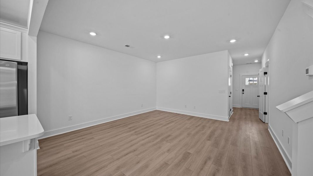 Tasteful family room with high ceilings, modern fixtures, and a warm, inviting feel