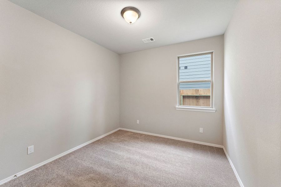 A room with a carpet and a window. A room with a carpet and a window.