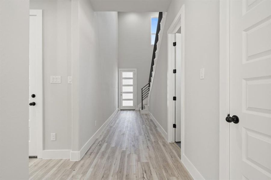 Hall featuring plenty of natural light and light hardwood / wood-style floors