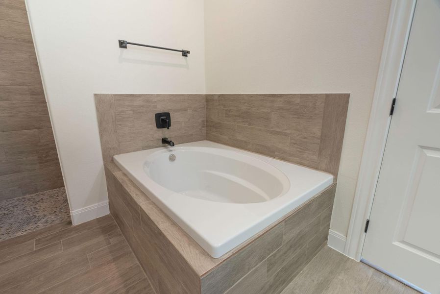 Bathroom with a bath and light wood finished floors Bathroom with a bath and light wood finished floors