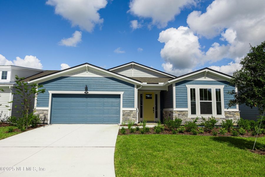 Front exterior of a new home in RiverTown - WaterSong, St. Johns, FL, highlighting curb appeal (Image 17).