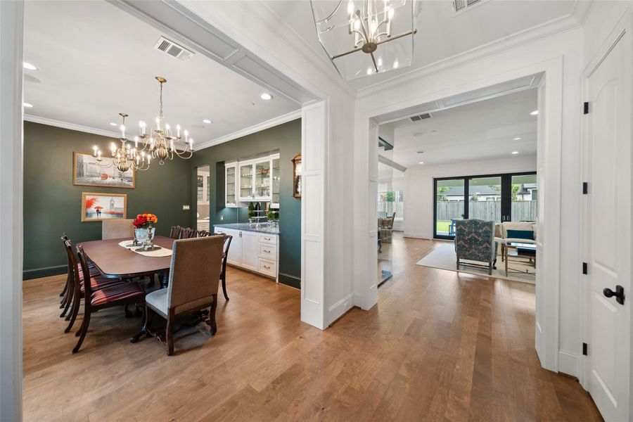 Front-facing view showcasing the dining room, entryway, and living area with an open, connected layout.