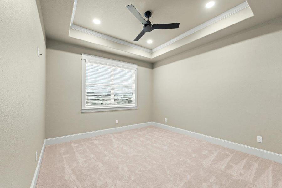 Tray ceiling with recessed lighting and a ceiling fan, neutral wall paint, white baseboards, and a window with blinds