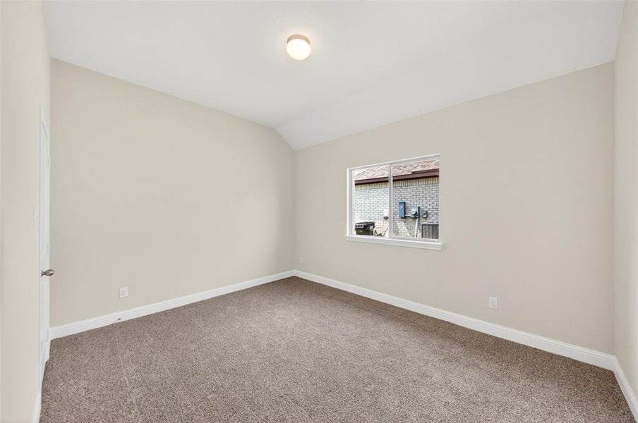 Neutral-toned walls complement the brown carpet flooring