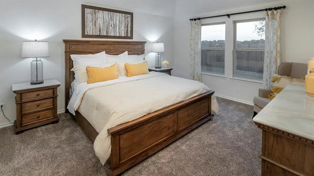 Bedroom with dark colored carpet and baseboards