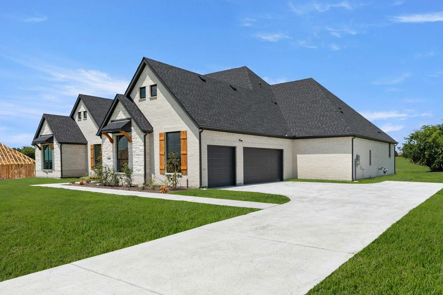 Front exterior of a new home in Heritage, McLendon-Chisholm, TX, highlighting curb appeal (Image 2). Front exterior of a new home in Heritage, McLendon-Chisholm, TX, highlighting curb appeal (Image 2).