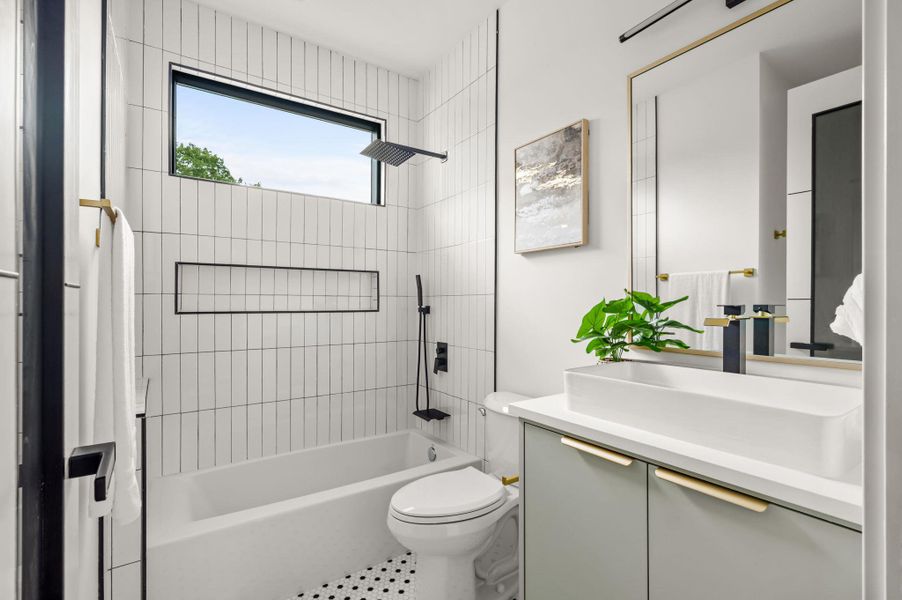 Modern bathroom features a sleek rectangular window, tiled tub/shower, and a contemporary vanity with a vessel sink. Modern bathroom features a sleek rectangular window, tiled tub/shower, and a contemporary vanity with a vessel sink.
