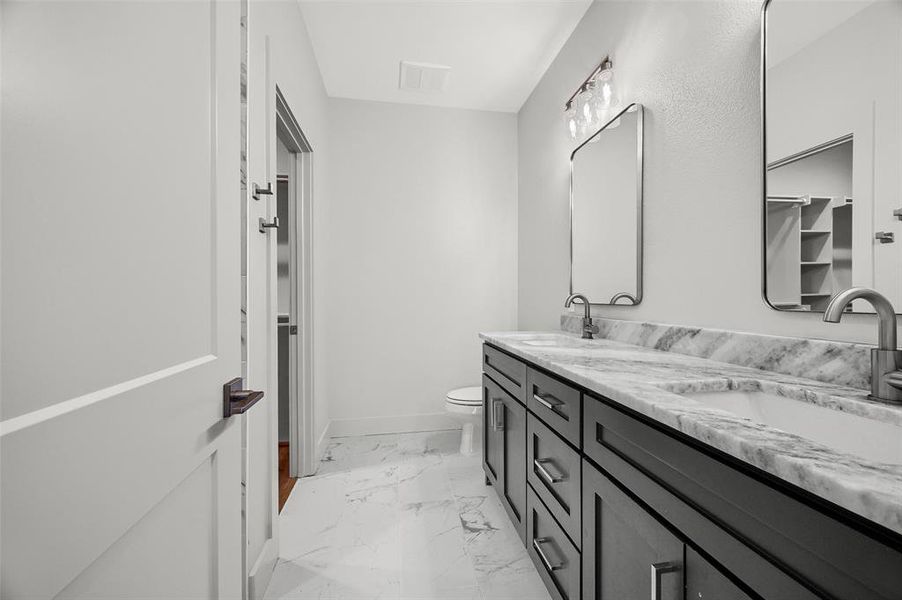 Dual sinks and beautiful stone vanity with extra storage