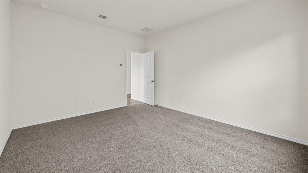 Spare room with carpet and baseboards