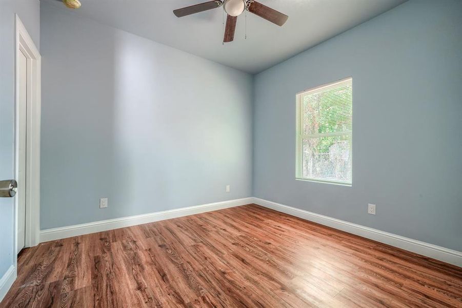 Spare room with ceiling fan and wood-type flooring