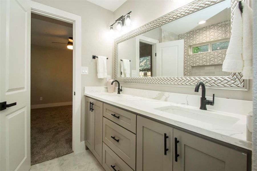 Bathroom with ceiling fan and vanity