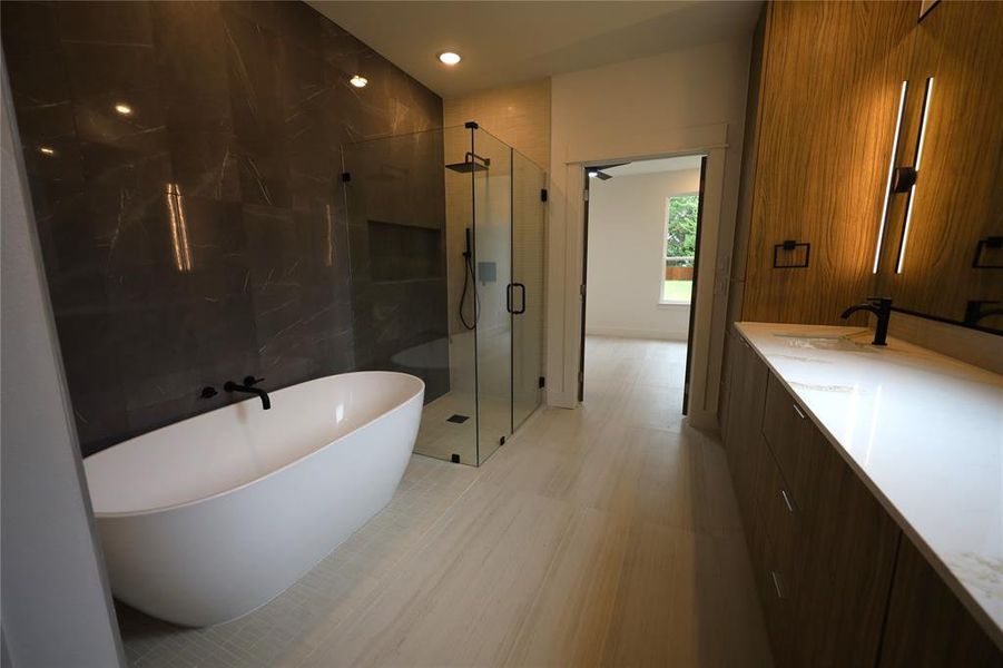 Full bath with a soaking tub, a marble finish shower, vanity, and recessed lighting