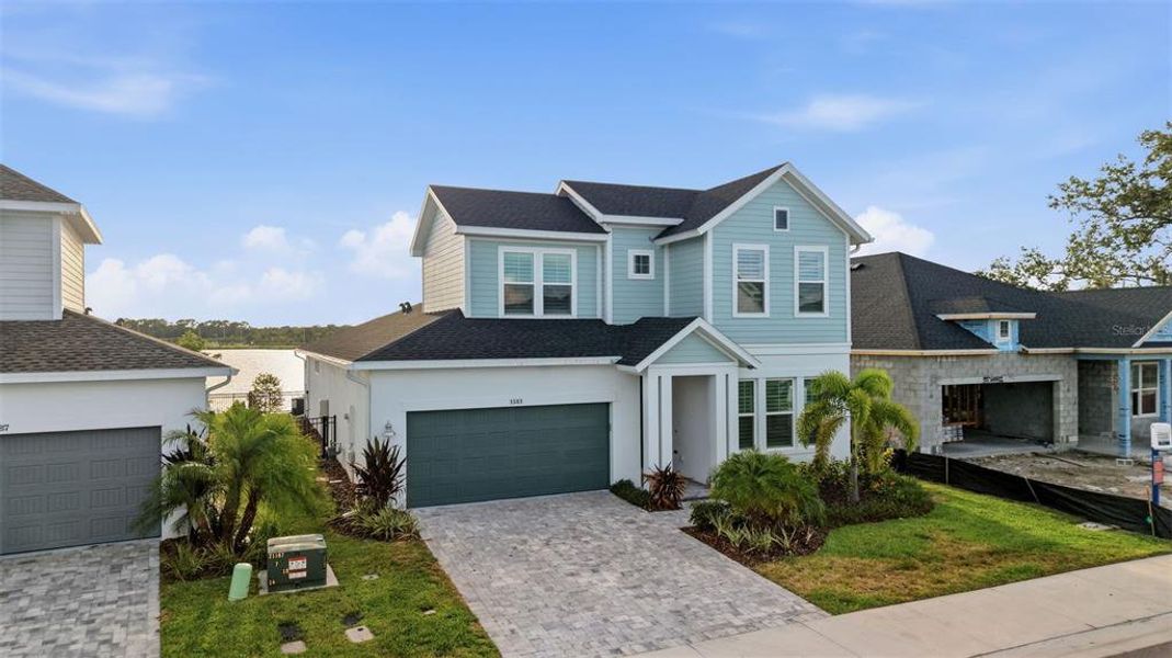 Front exterior of a new home in Emerald Landing at Waterside at Lakewood Ranch – Lake Series, Sarasota, FL, highlighting curb appeal (Image 27). Front exterior of a new home in Emerald Landing at Waterside at Lakewood Ranch – Lake Series, Sarasota, FL, highlighting curb appeal (Image 27).