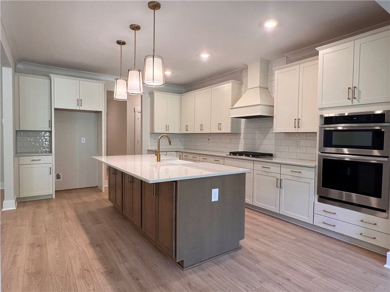 This spacious kitchen offers a large island, sleek