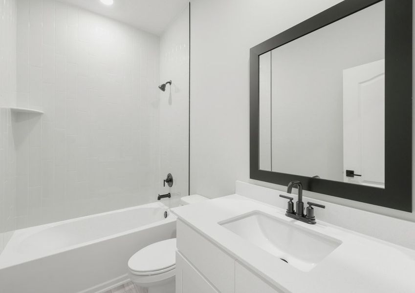 One of two secondary bathrooms that features a beautifully tiled shower