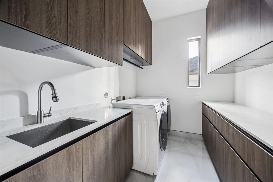 The large utility room is located upstairs, and has a sink.