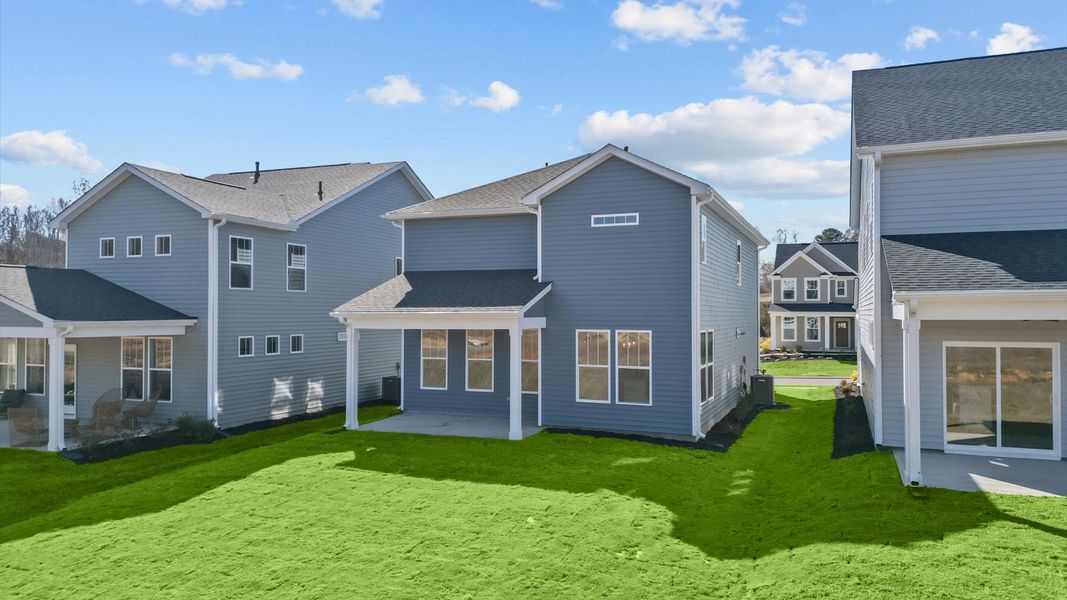 Vibrant rear outdoor space featuring a covered porch and exceptional craftsmanship