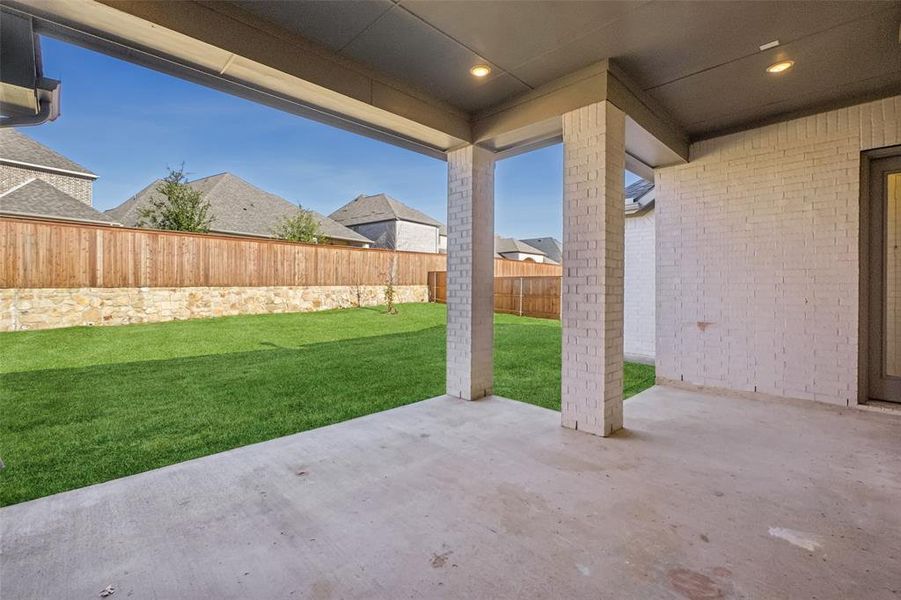 Fenced backyard with a patio area Fenced backyard with a patio area