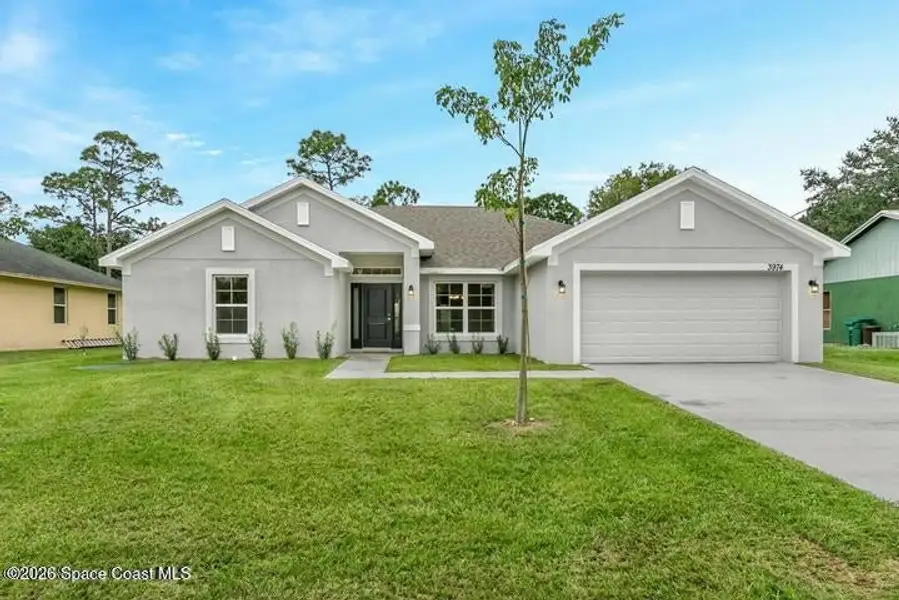 Front exterior of a new home in Palm Bay, Palm Bay, FL, highlighting curb appeal (Image 1). Front exterior of a new home in Palm Bay, Palm Bay, FL, highlighting curb appeal (Image 1).
