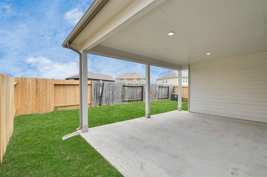 Backyard retreat, offering an abundance of space for kids to play and explore. The possibilities are endless in this outdoor haven, where the joy of open-air activities and family gatherings awaits. Sample photo of completed home with similar plan. As built color and selections may vary.