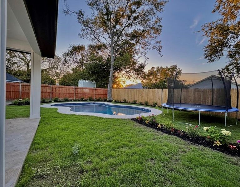 Fenced backyard featuring a virtual trampoline and a pool Fenced backyard featuring a virtual trampoline and a pool