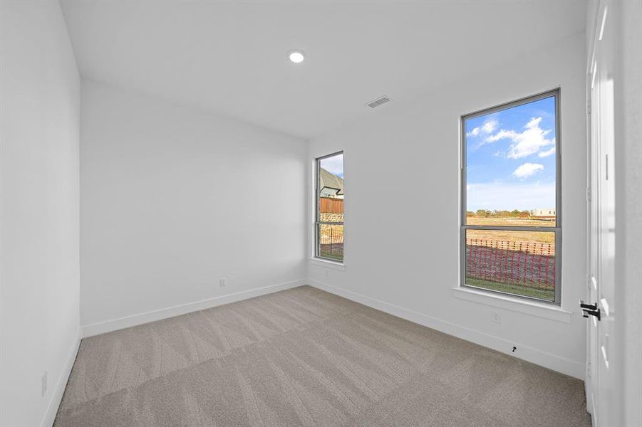 Unfurnished room featuring light colored carpet and recessed lighting
