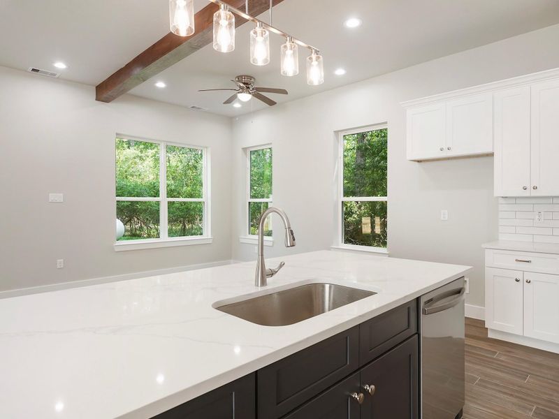 Kitchen is mix of navy blue island and white cabinets Kitchen is mix of navy blue island and white cabinets