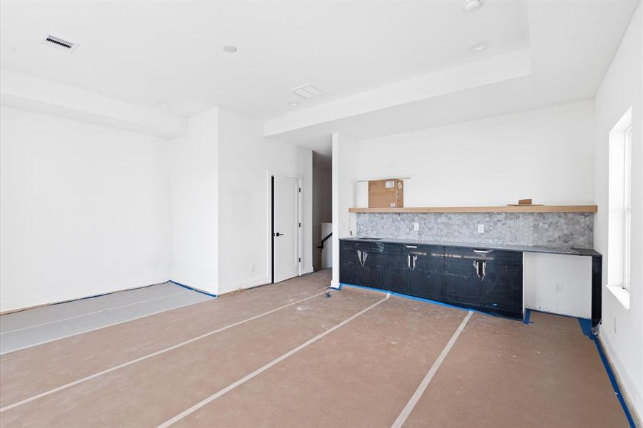 Third floor game room with built in bar.