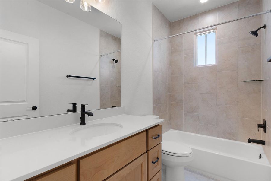 Bathroom featuring a vanity with a white countertop and wood cabinetry