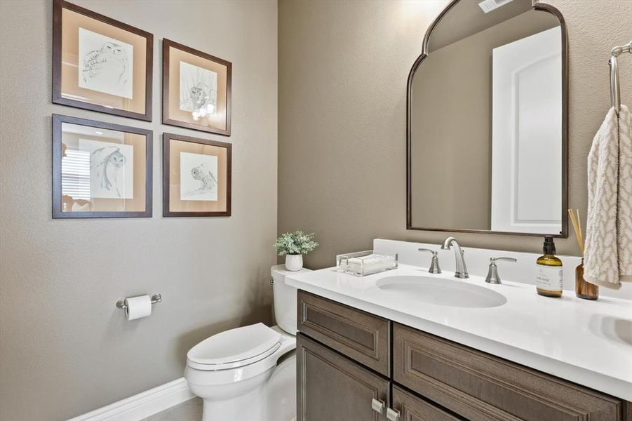 Bathroom with vanity and a textured wall