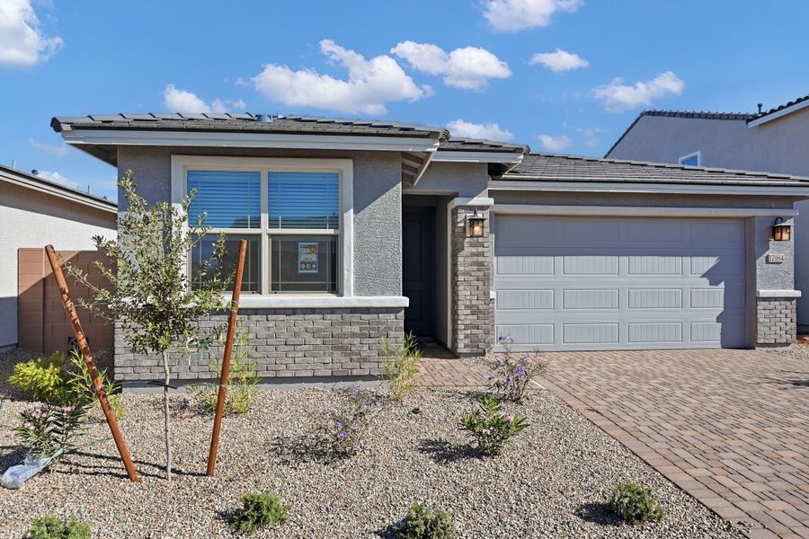 Front exterior of a new home in Artisan at Asante, Surprise, AZ, highlighting curb appeal (Image 2). Front exterior of a new home in Artisan at Asante, Surprise, AZ, highlighting curb appeal (Image 2).