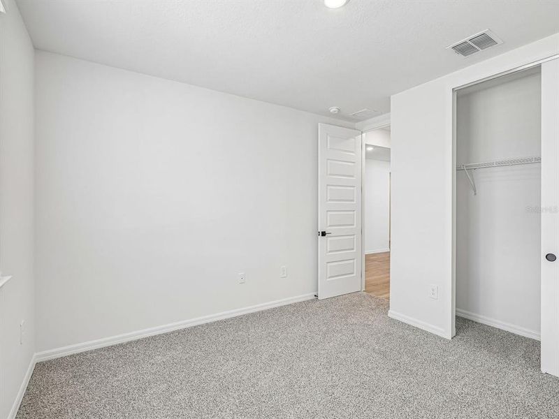 Spacious, unfurnished interior of a new home in The Grove at Stuart Crossing - Signature Series, Bartow (Image 13).