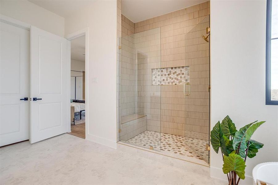 Full bathroom with a stall shower, tile patterned flooring, ensuite bathroom, and baseboards