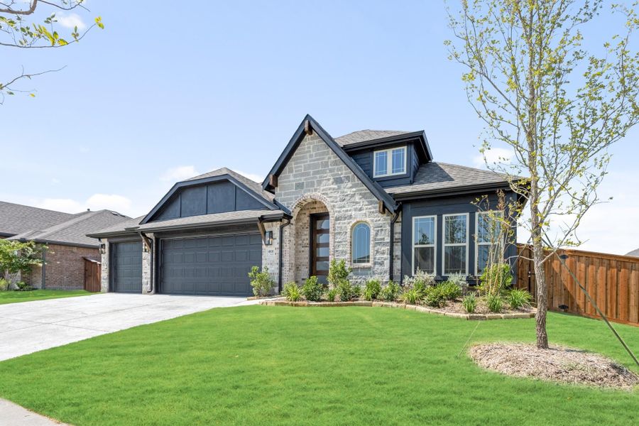 Single-story home with stone and dark siding exterior, two-car garage, and manicured front lawn Single-story home with stone and dark siding exterior, two-car garage, and manicured front lawn